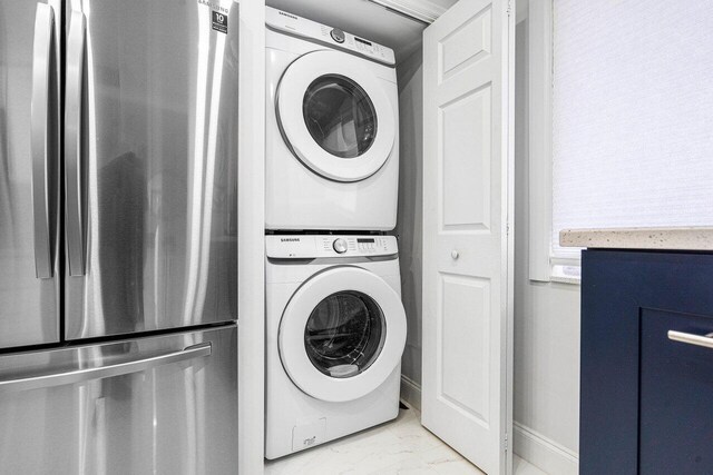 laundry room with stacked washer and clothes dryer