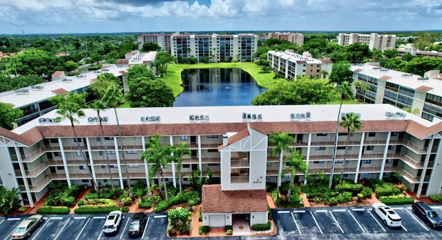 view of property featuring uncovered parking and a water view