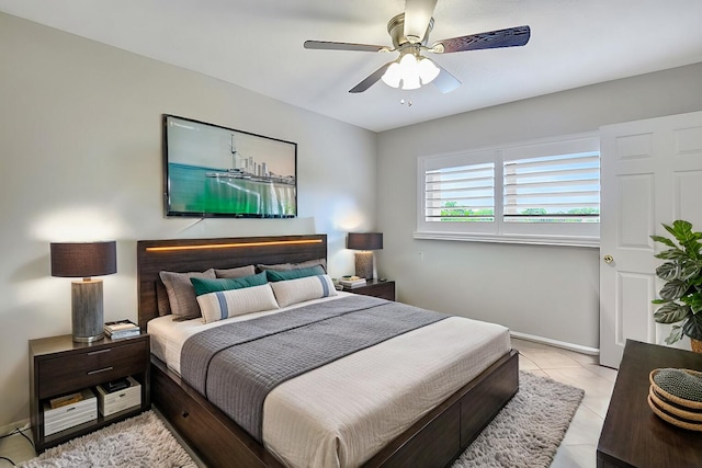 tiled bedroom featuring ceiling fan