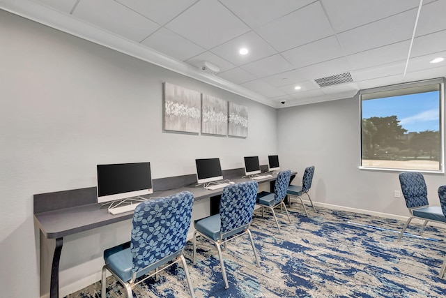 carpeted home office with a paneled ceiling