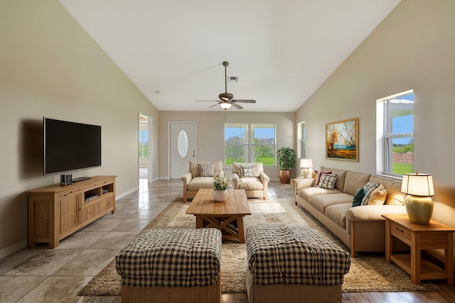 living room with high vaulted ceiling, light tile patterned floors, and ceiling fan