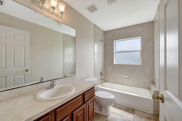 full bathroom with tiled shower / bath, vanity, tile patterned flooring, and toilet