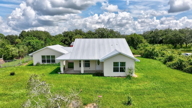 back of house with a lawn