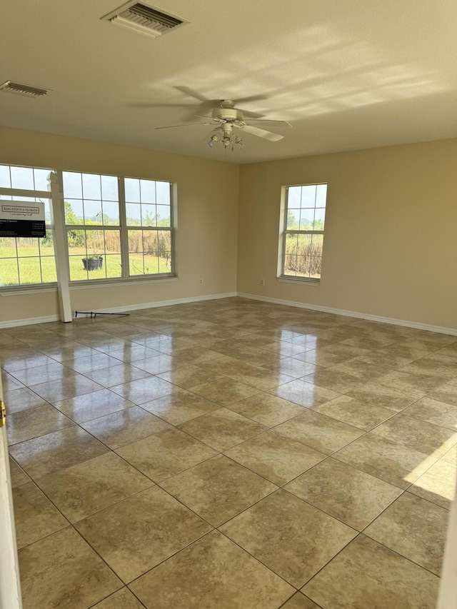 spare room featuring light tile patterned floors and ceiling fan