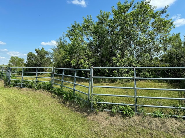 view of gate featuring a yard