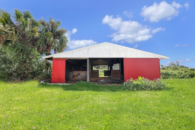 view of outdoor structure featuring a lawn