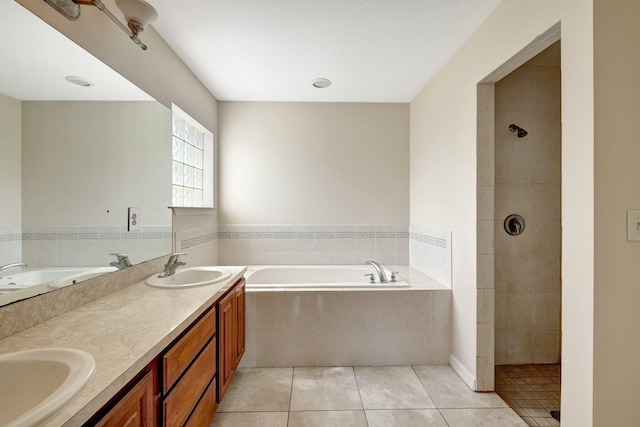 bathroom featuring vanity, plus walk in shower, and tile patterned floors