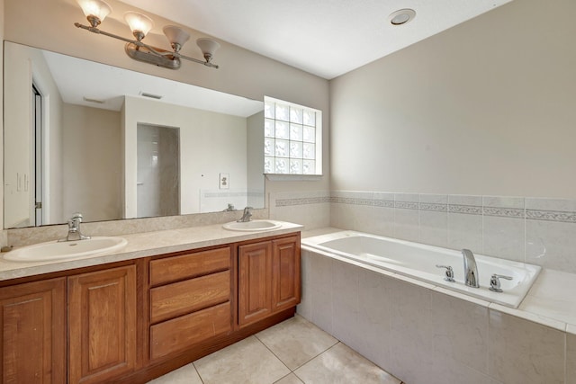 bathroom featuring vanity, tiled bath, and tile patterned floors