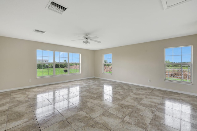 spare room with plenty of natural light, light tile patterned floors, and ceiling fan