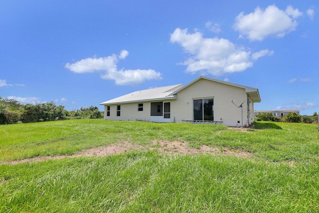 back of house with a lawn