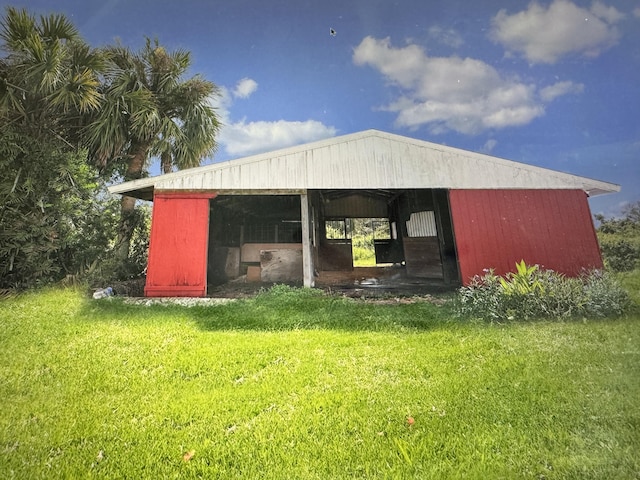 view of outbuilding featuring a yard