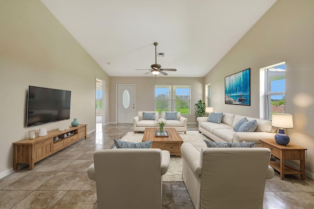 living room featuring ceiling fan, light tile patterned flooring, and high vaulted ceiling