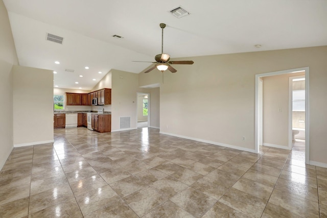 unfurnished living room featuring ceiling fan, light tile patterned flooring, and vaulted ceiling