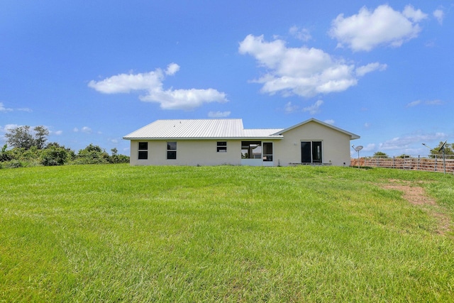 back of house with a yard