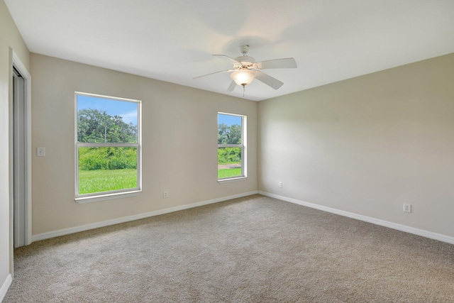 empty room with ceiling fan and carpet