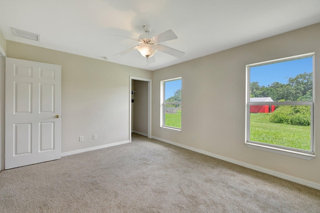 unfurnished room featuring light carpet and ceiling fan