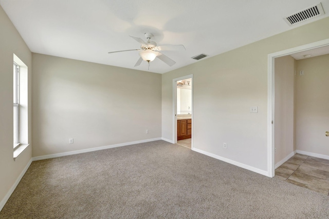 carpeted empty room featuring ceiling fan