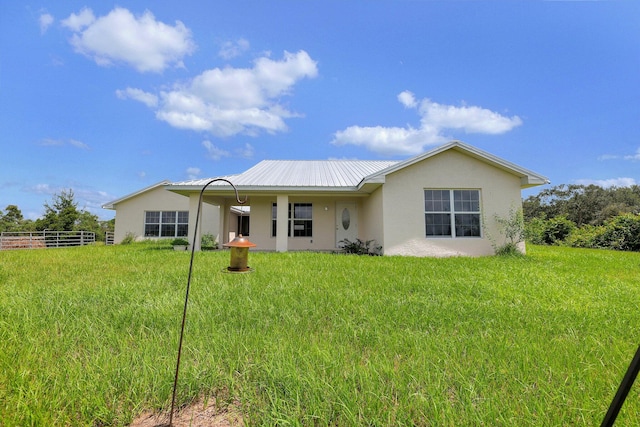 rear view of house with a yard