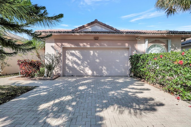 mediterranean / spanish-style home with a garage