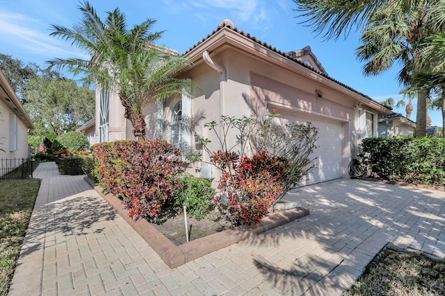 view of side of home featuring a garage