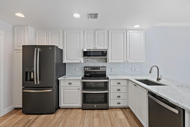 dining space featuring a textured ceiling, light hardwood / wood-style floors, and ornamental molding