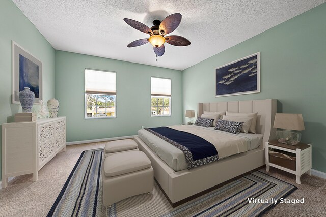 home office with carpet, a textured ceiling, and ceiling fan