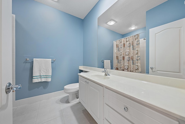 full bath featuring toilet, baseboards, a textured ceiling, and tile patterned floors