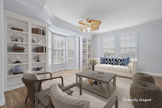 living room featuring wood-type flooring, crown molding, and a textured ceiling