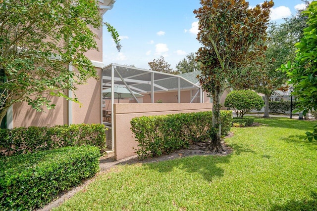 view of yard with glass enclosure