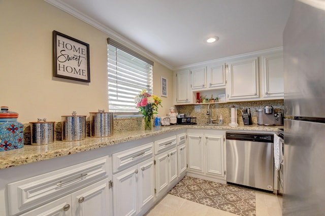 kitchen featuring appliances with stainless steel finishes, light tile patterned flooring, white cabinets, and crown molding