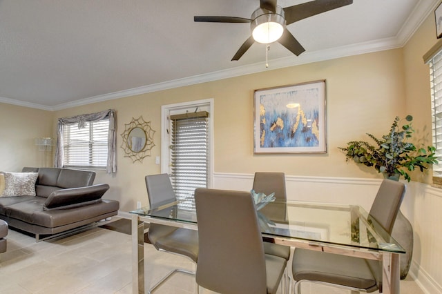 dining room with ornamental molding, light tile patterned flooring, and ceiling fan