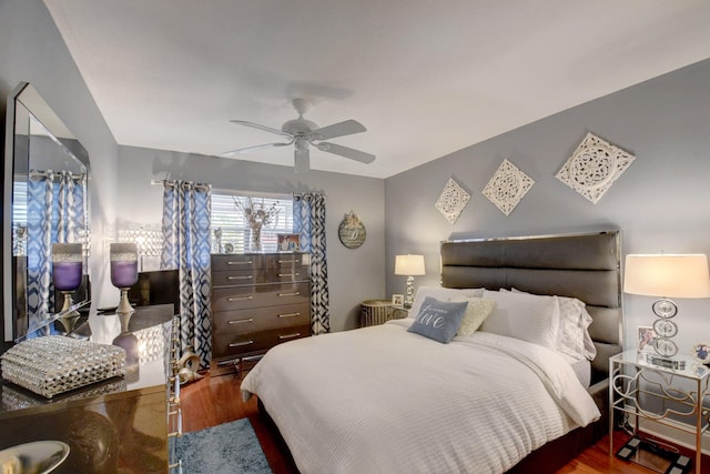 bedroom with dark wood-type flooring and ceiling fan