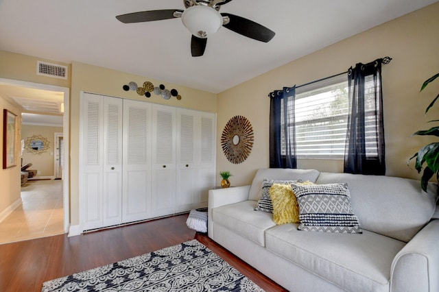 living room with wood-type flooring and ceiling fan