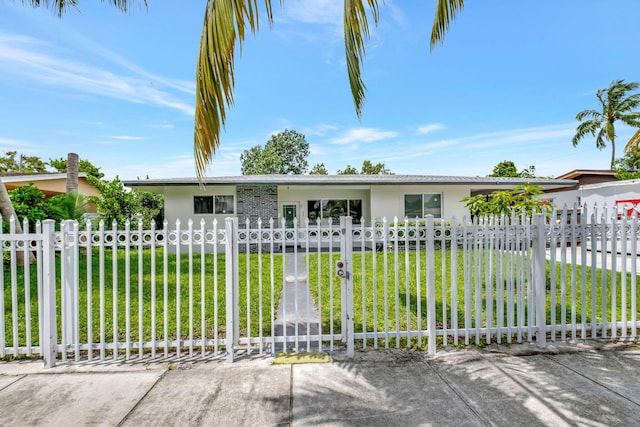 ranch-style home with a front lawn