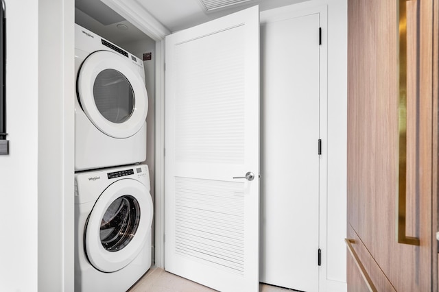 laundry room with stacked washer / drying machine