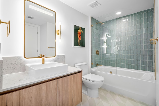 full bathroom with vanity, toilet, and tiled shower / bath combo