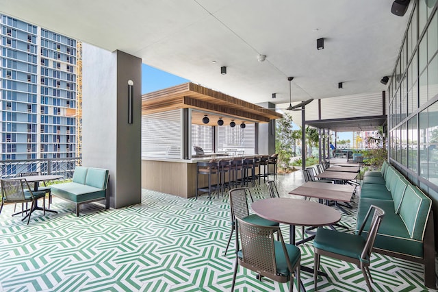 view of patio / terrace with a bar and outdoor lounge area