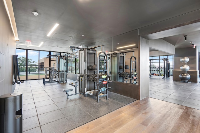 exercise room featuring hardwood / wood-style floors and expansive windows