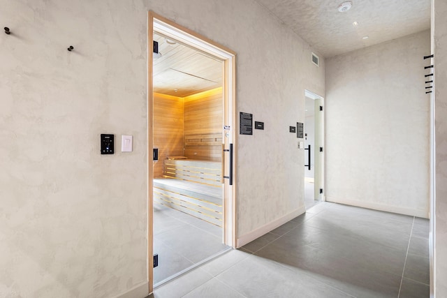 hallway with tile patterned flooring