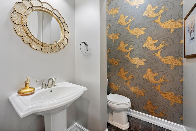 bathroom featuring sink, wood-type flooring, and toilet