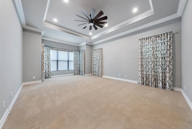 unfurnished room with a tray ceiling, carpet flooring, and ceiling fan