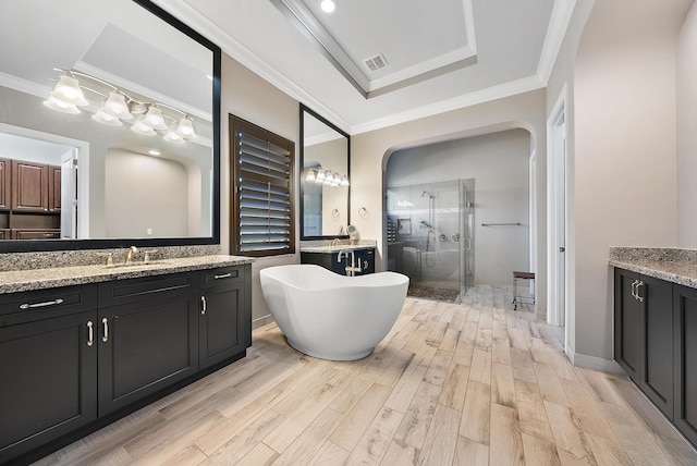 bathroom featuring crown molding, separate shower and tub, vanity, and hardwood / wood-style flooring