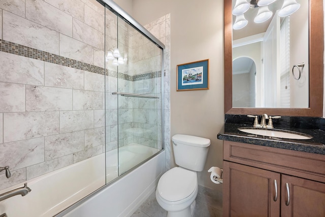 full bathroom featuring ornamental molding, tile patterned floors, vanity, combined bath / shower with glass door, and toilet