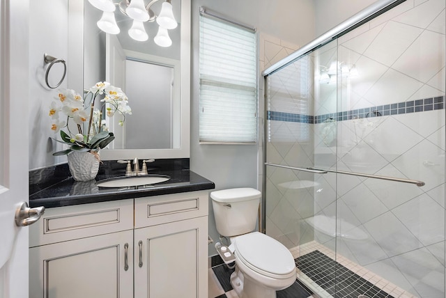 bathroom with an enclosed shower, toilet, and vanity