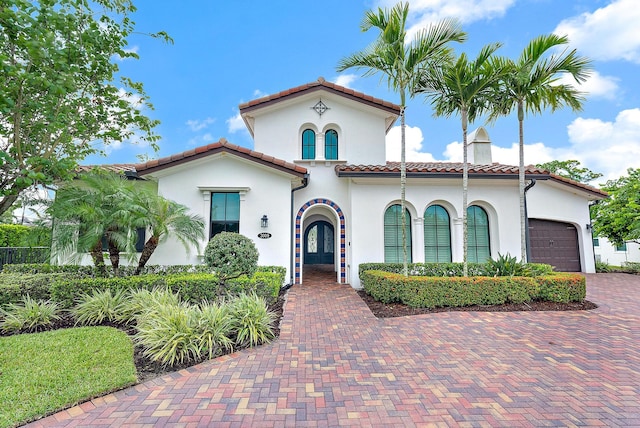 mediterranean / spanish-style house featuring a garage