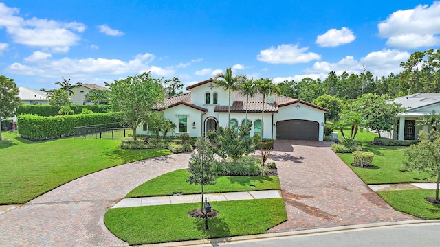 mediterranean / spanish-style house with a garage and a front yard