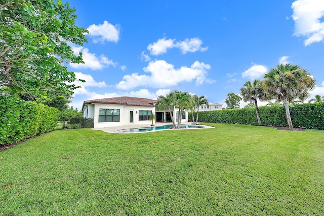 view of yard with a fenced in pool and a patio area