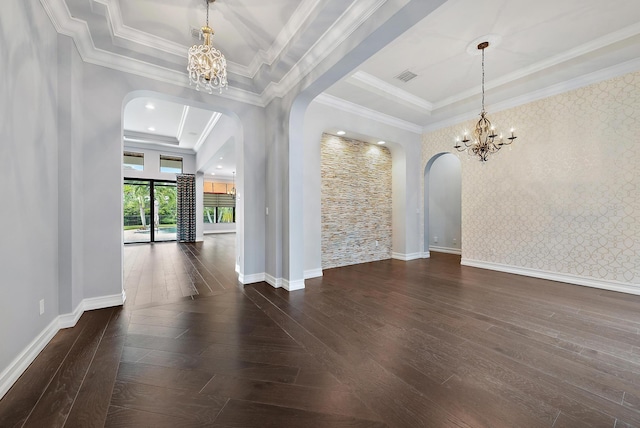 spare room featuring a tray ceiling, crown molding, and an inviting chandelier