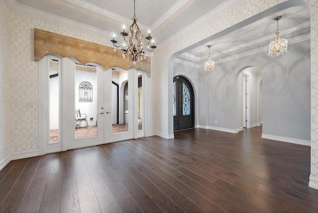 foyer featuring crown molding, wood-type flooring, french doors, and a chandelier