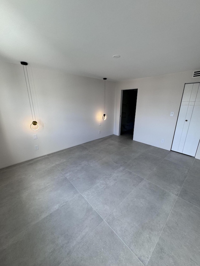 unfurnished bedroom featuring visible vents